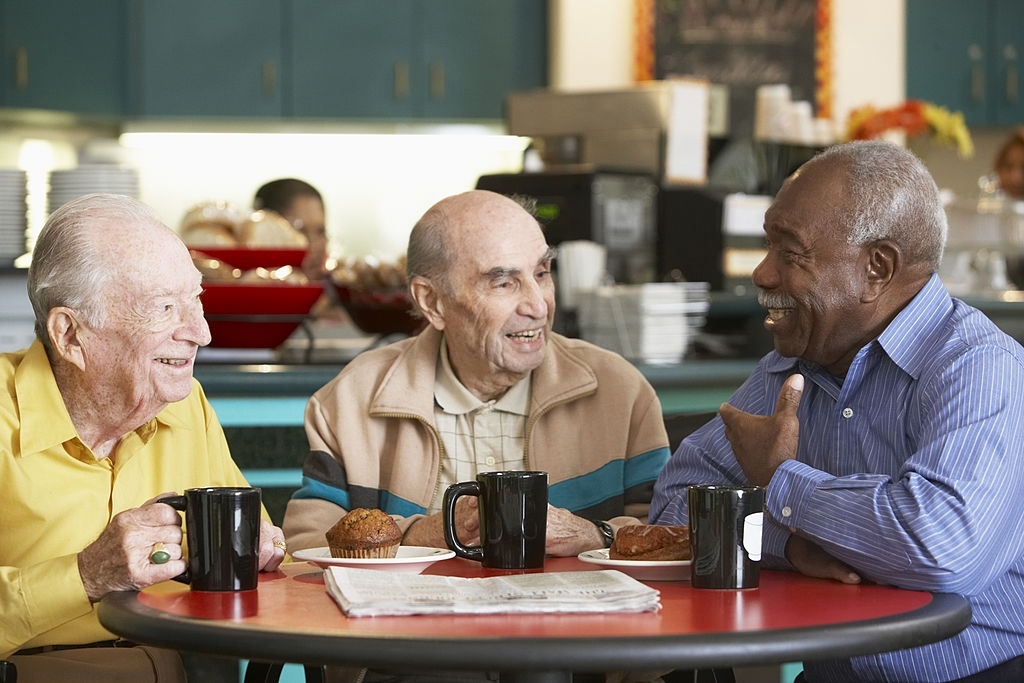 Senior men drinking tea together and chatting